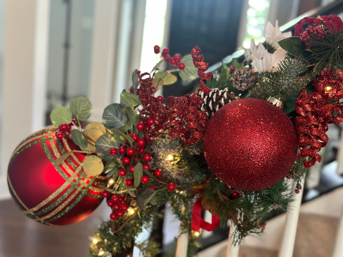 Red Christmas garland with ornaments, greenery, and berries